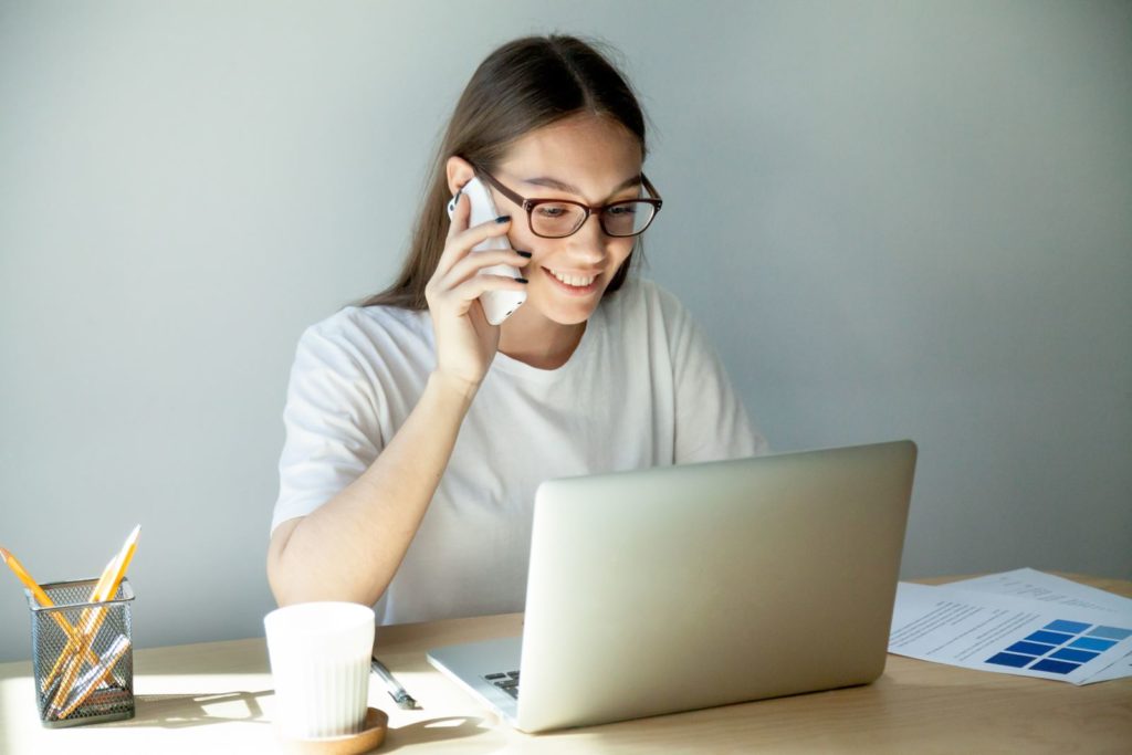 Person on phone at computer